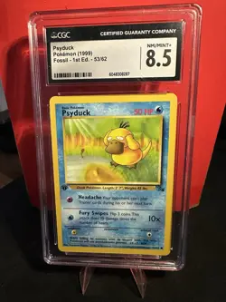 1999 Psyduck Fossil 1st Edition Pokemon TCG Card 53/62 HP - CGC 8.5 - NM/MINT+ - Image 1