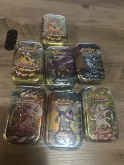 Pokemon Prismatic Evolutions Tins Lot Of 7 - Image 1