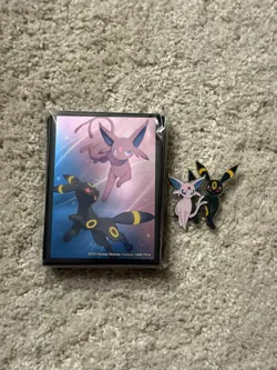 Pokemon TCG - Prismatic Evolutions Figure Collection Sleeves and Pin - Image 1