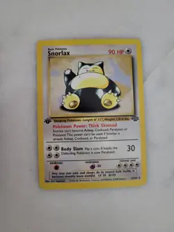 Pokemon Snorlax 27/64 Base Set 1st Edition w/ Top Loader - Image 1