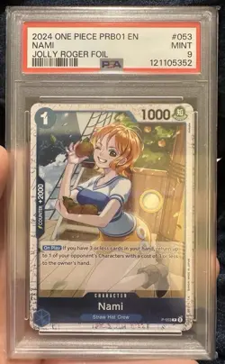 2024 ONE PIECE PRB01-053 NAMI PSA 9 JOLLY ROGER FOIL PREMIUM BOOSTER #53 - Image 1