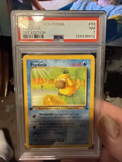 1999 POKEMON FOSSIL 1ST EDITION #53 PSYDUCK PSA 7 - Image 1