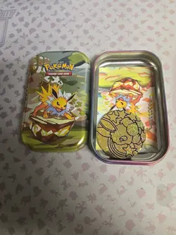 *EMPTY NO PACKS* Pokemon Prismatic Mini Tin Includes Art Card & Coin. Jolteon - Image 1