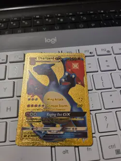 This is a gold foil Pokemon trading card featuring the character Charizard-GX. I - Image 1
