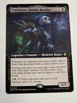 Tinybones, Bauble Burglar Ext Art - Foundations MTG - Image 1
