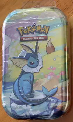 POKEMON TCG PRISMATIC EVOLUTIONS VAPOREON MINI TIN, 2 Booster Packs, EEVEE Coin - Image 1