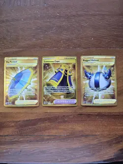Pokemon 3 Card Lot Gold Trainers (Luxurious Cape, Big Parasol, Rugged Helmet) - Image 1