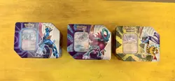 Pokemon TCG: Paradox Clash Tin Set of 3- Iron Crown, Walking Wake, & Raging Bolt - Image 1