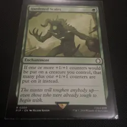 1x Hardened Scales - Universes Beyond: Fallout - NM - MTG - Image 1