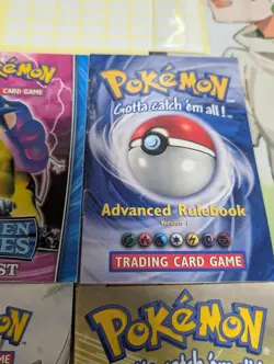 Pokemon Rule Book/Card List Lot with 6 Booklets, 2 Old Playmats, & Deck Box - Image 2