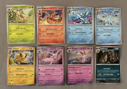 Pokemon Prismatic Evolutions Costco Mini Tin Cosmo Promos 8 Umbreon Sylveon - Image 1