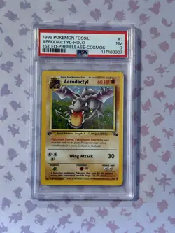 1999 POKEMON FOSSIL 1ST ED-PRERELEASE-COSMOS #1 AERODACTYL-HOLO PSA 7 - Image 1