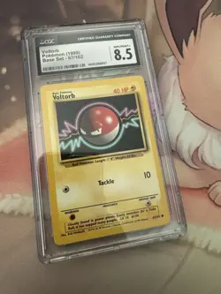 Pokemon 1999 Voltorb 67/102 Base Set Unlimited CGC 8.5 - Image 1