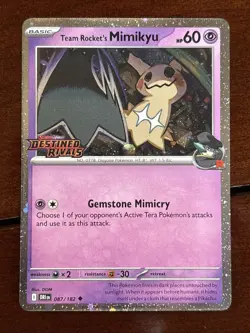 Pokemon Destined Rivals Team Rocket’s Mimikyu Stamped Promo 087/182 Cosmo Holo - Image 1