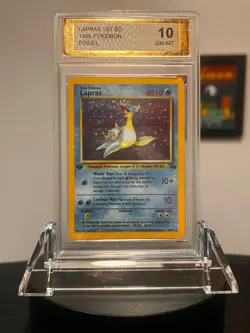 1999 POKEMON FOSSIL 1ST ED #10 LAPRAS-HOLO PGC 10 - Image 1