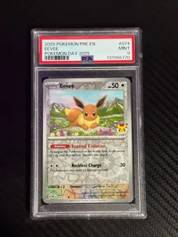 2025 POKEMON PRISMATIC EVOLUTIONS POKEMON DAY 2025 EEVEE #074 PSA 9 Card - Image 1