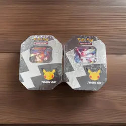 Pokemon 25th Anniversary Celebrations Tin Set: Lance's Charizard - Set of 2 Tins - Image 1