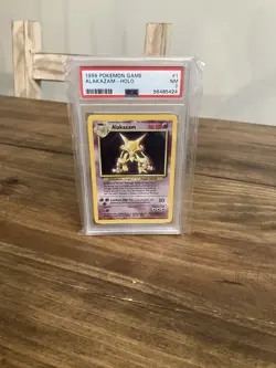 1999 POKEMON BASE SET #1 ALAKAZAM-HOLO PSA 7 - Pokemon Card PSA Graded - Image 1
