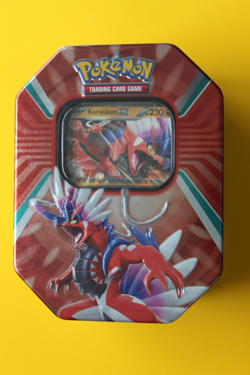 POKEMON TCG KORAIDON EX TIN SEALED SMALL DENT ON SIDE OF EX - Image 1
