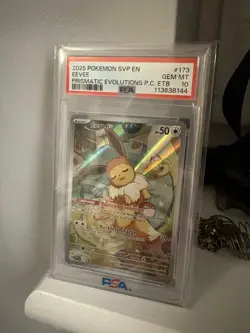 2025 POKEMON PRISMATIC EVOLUTIONS POKEMON CENTER ETB PROMO SVP #173 EEVEE PSA 10 - Image 1