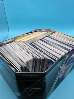 600 +- Pokemon Cards Bulk In Tin Imcludes Holos/Uncommon/Common/Rares - Image 1