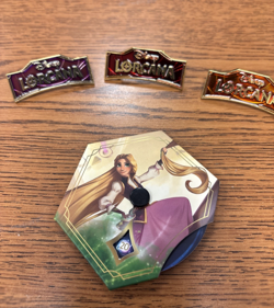 Disney Lorcana - Red, Purple and Orange Logo Pins And Rapunzel Lore Counter - Image 1