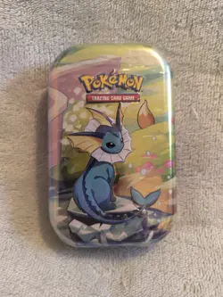 Pokemon TCG: Scarlet & Violet—Prismatic Evolutions Mini Tin – Vaporeon - Sealed - Image 1