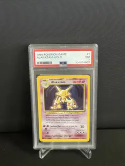1999 Pokemon Base Set Alakazam Holo 1/102 PSA 7 NM - Image 1