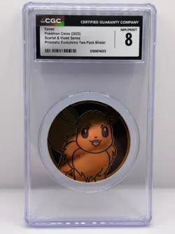 Pokemon 2025 Eevee Coin (Large) Prismatic Evolutions Blister CGC 8 NM/MINT - Image 1