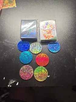Set Of 7 Pokemon PRISMATIC EVOLUTIONS Jumbo Eevee Coins And Sleeves Unopned - Image 1