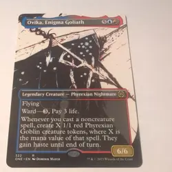 Ovika, Enigma Goliath - Borderless - Phyrexia all will be one - MTG - Image 1