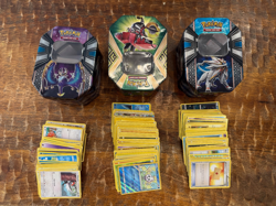 Pokemon Tins with random card lot + 11 Pokemon-GX cards, gently used condition - Image 1