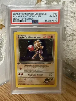PSA 8 Rocket's Hitmonchan 11/132 Gym Heroes 1st Edition Holo Rare Pokemon TCG - Image 1