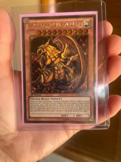The Winged Dragon of Ra PGLD-EN031 Premium Gold 1st Edition gold secret rare - Image 1