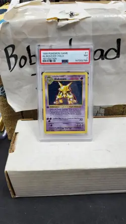 1999 ALAKAZAM HOLO FOIL 1ST EDITION SHADOWLESS BASE SET POKEMON TCG PSA 7 #1/102 - Image 1
