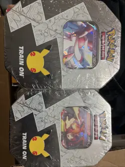 Pokemon 25th Anniversary Celebrations Tin Set: Lance's Charizard & Dark Sylveon - Image 1