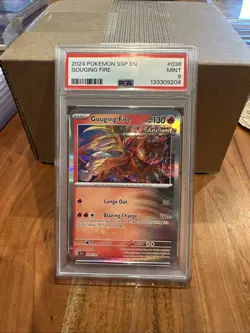 2024 Pokemon SSP EN-SURGING SPARKS GOUGING FIRE #038 PSA MINT 9 - Image 1
