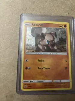 Rockruff SM06 Black Star Promo COSMOS Holo Pokemon Card LP 2017 Small Crease - Image 3