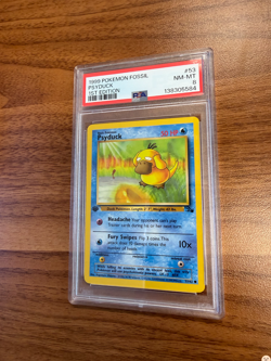 PSA 8 1999 POKEMON FOSSIL #53 PSYDUCK 1ST EDITION - Image 1