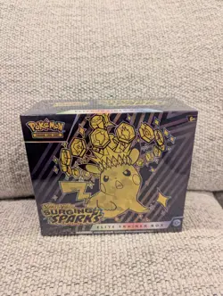 Pokemon TCG Surging Sparks ETB Factory Sealed - in hand - Image 1