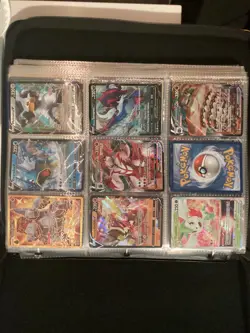 pokemon cards in a big book lots of different cards found in different packs - Image 1