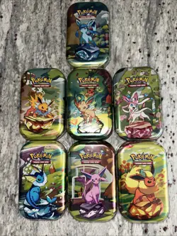 7, POKEMON PRISMATIC EVOLUTIONS MINI TIN NEW/SEALED MINT - Image 1