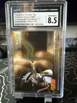 Trying Out the New Toy cgc 8 NM/MINT Pokemon Topps 1999 First Print Silver Foil - Image 1