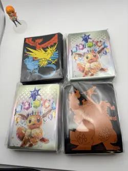 Pokemon Premium Card Sleeves Eevee Charizard Legendary Birds x4 lot - Image 1