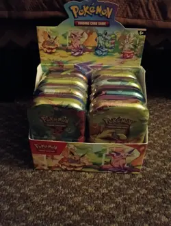 Pokemon TCG Prismatic Evolutions Full Set of 8 Sealed Mini Tins With Display - Image 1
