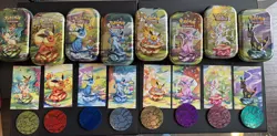 Prismatic Evolutions Tins - Set of 8 - Tins, Art Cards, and Coins only- No cards - Image 1