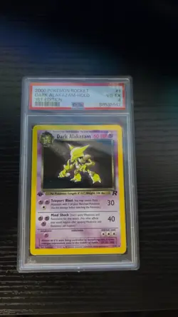 2000 POKEMON TEAM ROCKET 1ST EDITION #1/82 DARK ALAKAZAM HOLO PSA 4 - Image 1