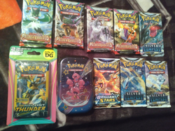Pokemon SEALED LOT paldean fates tin, lost thunder 3 card blister, + 8 packs - Image 1