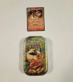 Pokemon Prismatic Evolutions Flareon TCG Mini Tin + Flareon Foil Card TIN DENTED - Image 1