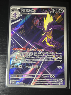 Toxtricity 103/094 Me02: Phantasmal Flames Holo Pokemon - Image 1
